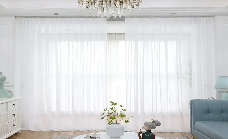 White sheer fabric curtain hanging on a window
