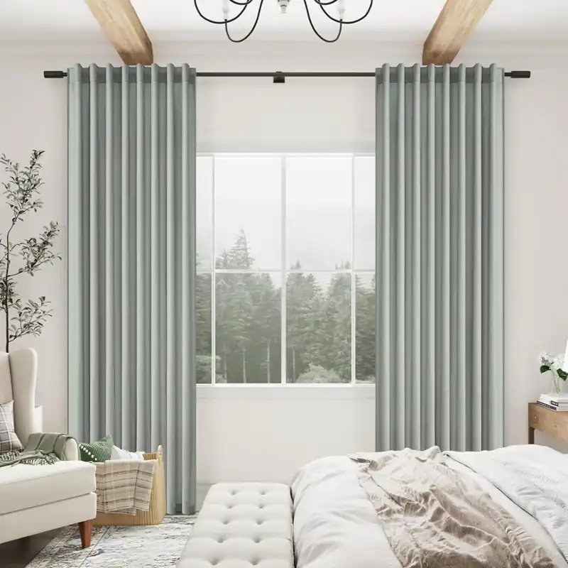Green wave curtains dubai framing a large window